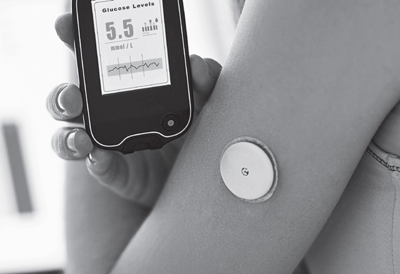 Hand holding a glucose meter